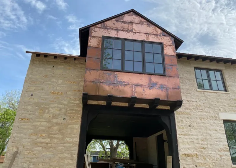 Copper metal panel facade on a stone building for Roof Repair in Perinton